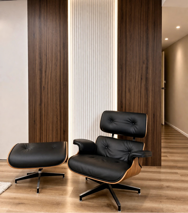 Modern black leather chair and ottoman in a room with wooden walls and floor.