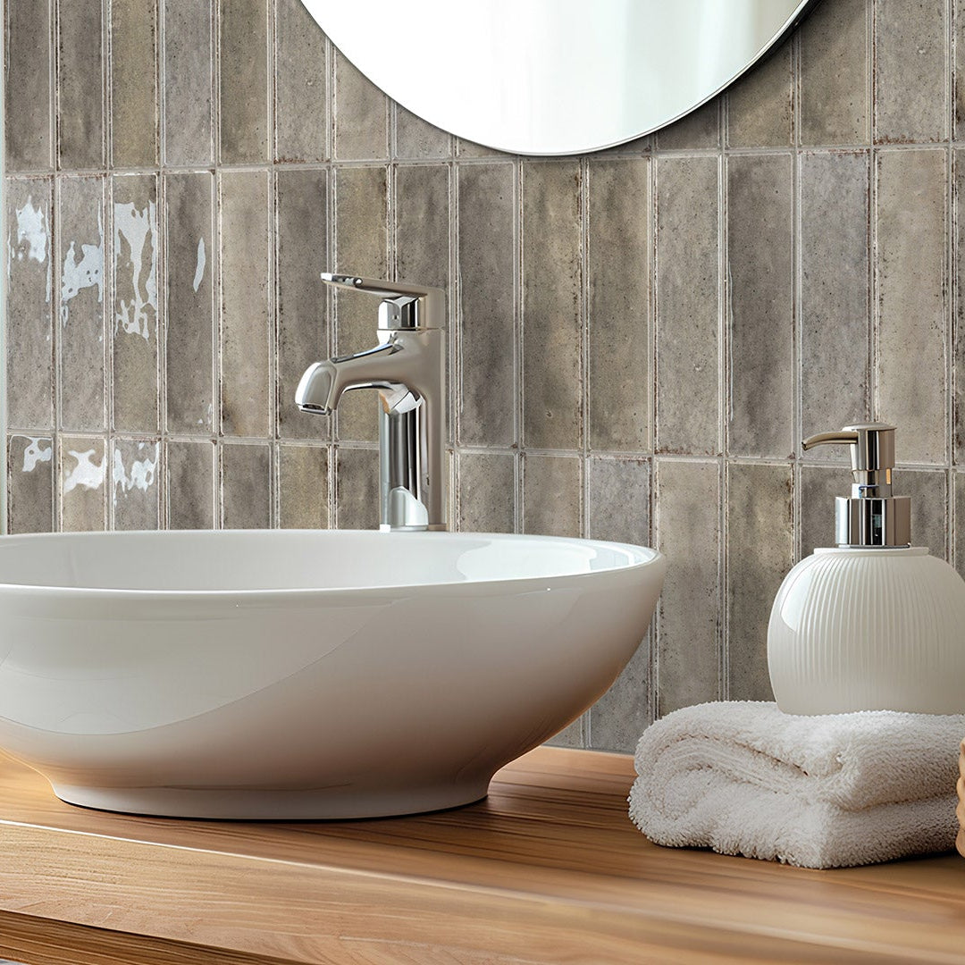 Bathroom vanity with a white sink, wooden countertop, and tiled wall.
