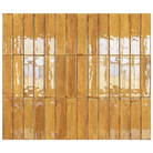 Rectangular glossy ceramic wall tiles in a warm golden-brown color, arranged in a grid pattern with grout lines.