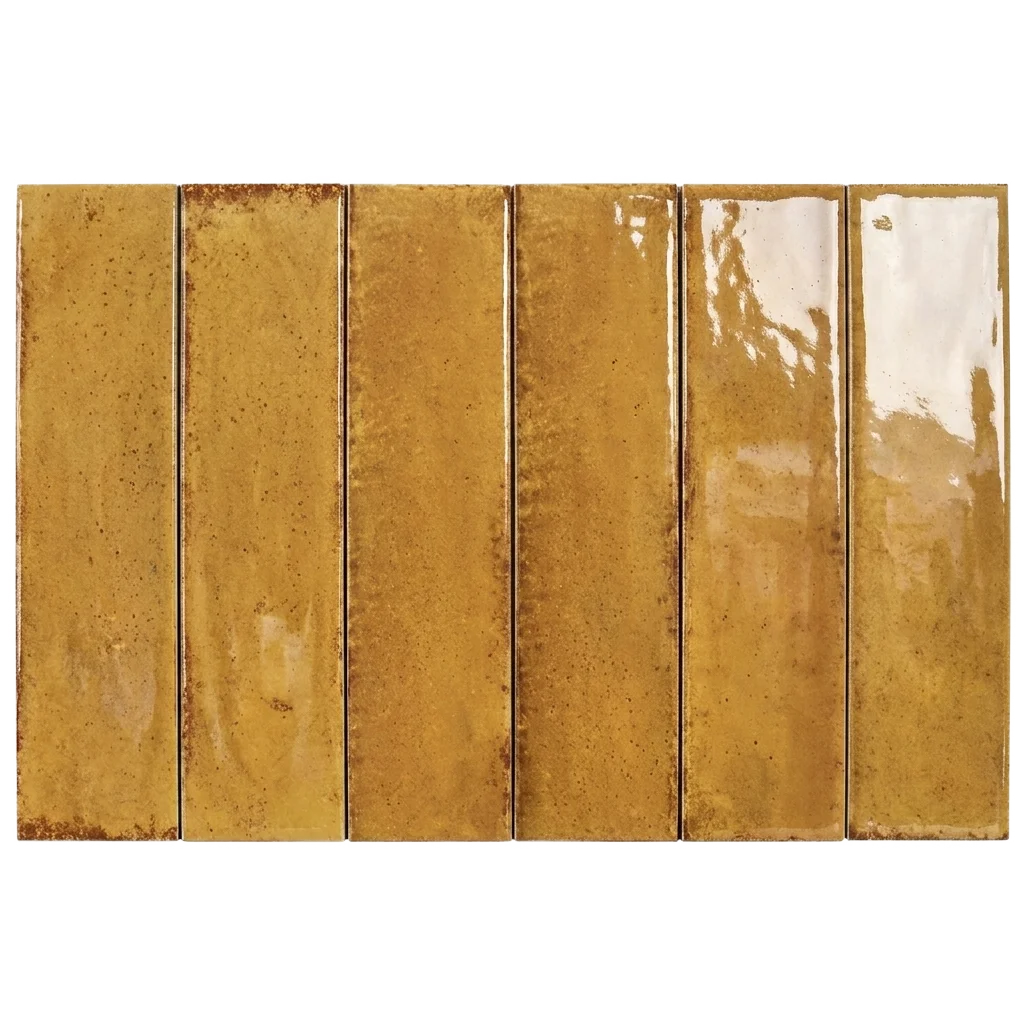 Six rectangular glossy ceramic subway tiles in a warm mustard-gold and amber color with subtle brown speckling and natural glaze variation, arranged side-by-side on a white background.