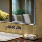 Bathroom sink with flowers and mirror reflecting the room
